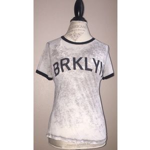 Light grey t-shirt with “BRKLYN” in black letters.